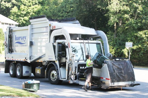 Dump Refuse Cars By Hand Into Front Load Garbage Truck