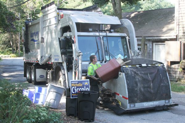 Garbage Man Using Automated Trash Truck